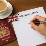 Person writing an invitation letter for a UK visa beside a UK passport
