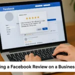 User writing a Facebook review on a laptop screen
